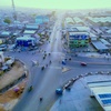 Aerial view of a busy urban intersection in a city during early morning.