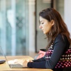 Undergraduate: woman with computer at IE tower