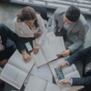 A group of professionals reviewing documents around a table.