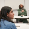 A group of people engaged in a discussion in a classroom setting.