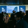 A group of people gathered at the Tech Foresight Summit 2024 event with a university backdrop.