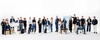 A diverse group of professionals standing and sitting together in a bright, minimalistic studio.