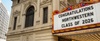 A marquee sign congratulates the Northwestern Class of 2026 displayed on a theater building.