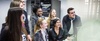 A group of people gathered around a computer, looking engaged and smiling.