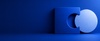 The image features a blue abstract shape consisting of a square with a circular cutout alongside a separate circle.