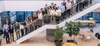 A group of people standing on a staircase in a modern indoor setting.