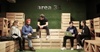 Five people having a casual meeting on wooden bleachers in a creative office space labeled 'area 31'.