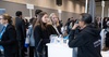 A group of people engaged in conversation at a professional event.