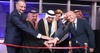 A group of people participating in a ribbon-cutting ceremony.