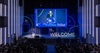 A speaker addresses an audience at a welcome event for a university.