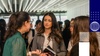 A group of young women engaged in a conversation at a social event.