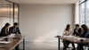A group of professionals is engaged in a collaborative meeting around a conference table.