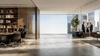 A modern office interior featuring a meeting area and a panoramic view of the cityscape.
