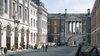 A historical architectural scene featuring classical buildings and an archway.