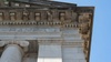 The image showcases the intricate architectural details of a building's upper façade.