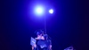 Graduates celebrating their achievement with a joyful embrace under spotlight.