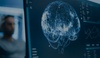 A digital representation of a brain illuminated on a computer screen.
