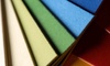 Close-up view of stacked colorful paper sheets.