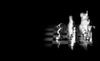 A close-up of a silver knight chess piece on a dark chessboard.
