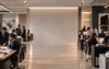 A modern office space bustling with professionals working at their desks.