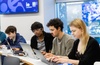 A group of students engaged in their studies at a university classroom.