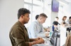 Two students are focused on their work at a modern classroom setting.