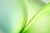 An abstract image featuring overlapping smooth curves in shades of green.