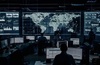 A high-tech control room with screens displaying global data and analytics.