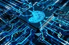 A close-up view of a microchip surrounded by intricate blue circuitry.