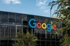 A modern building with the Google logo prominently displayed on its glass facade.