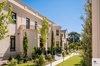 A modern building with lush greenery and well-maintained landscaping.