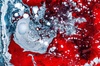 An abstract image featuring swirling red and blue colors with intricate textures and patterns.