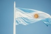 The Argentine flag waving under a clear blue sky.