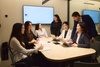 A group of young professionals collaborating in a modern meeting room.