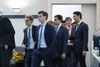A group of young professionals in formal attire walking together.