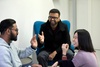 A group of three people engaged in a lively conversation.