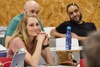 A group of people attentively listening during a presentation.