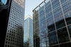 The image showcases a group of modern skyscrapers with reflective glass exteriors.