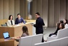 A group of professionals engaged in a presentation or discussion in a modern conference room.