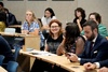 A group of people engaged in a conference or meeting setting.