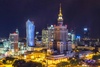 A stunning night view of Warsaw's skyline featuring modern skyscrapers and the Palace of Culture and Science.