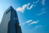 A tall modern skyscraper against a clear blue sky.