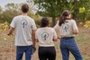 Three IE students giving their bags in the forest