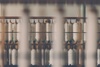 A blurred view of spools of thread on racks in a textile manufacturing setting.