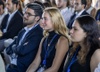 A group of young adults attentively listening at an event.