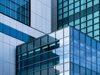 An abstract view of modern architectural glass and metal facades.
