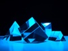 A collection of transparent geometric shapes illuminated with blue light.