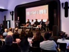 A panel discussion taking place in front of an audience.
