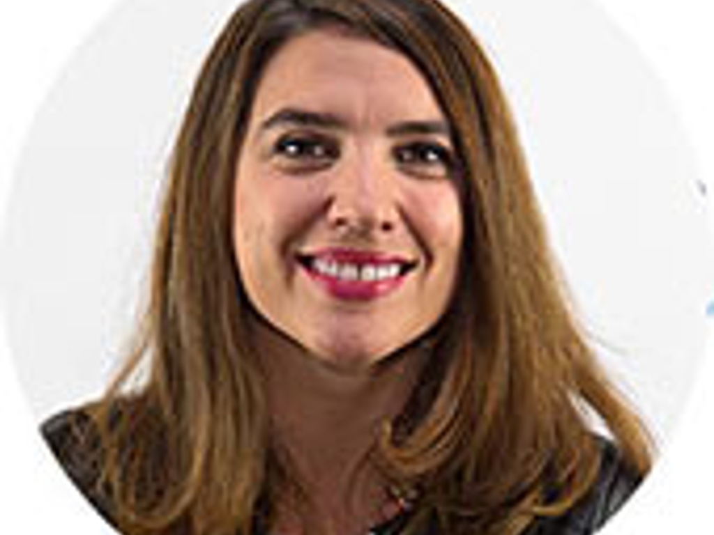 A smiling woman with long brown hair in a professional setting.