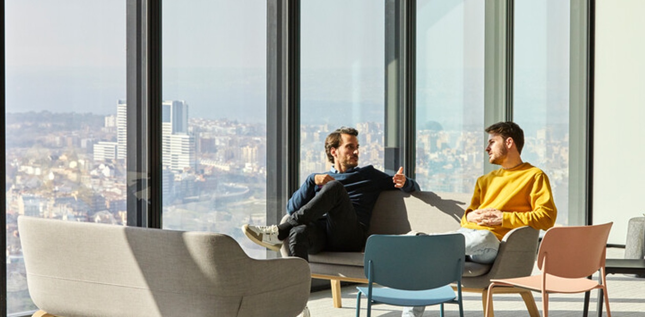 Two IE Executive MBA students sitting near a window